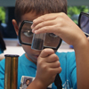 Student using a magnifying glass to view rocks