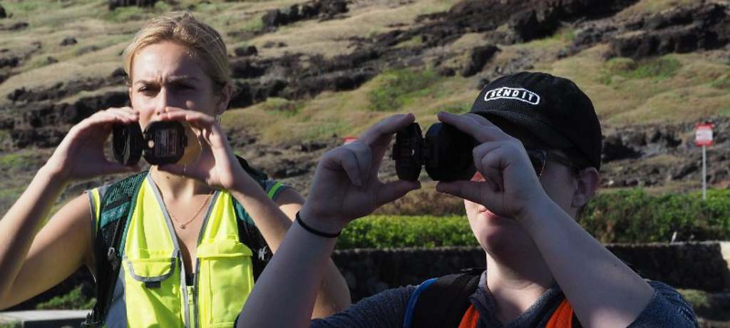 Students with brunton compass in the field