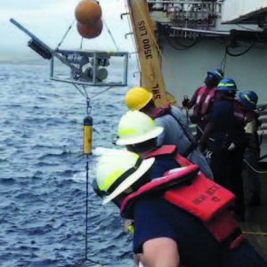 Deck workers watching an instrument