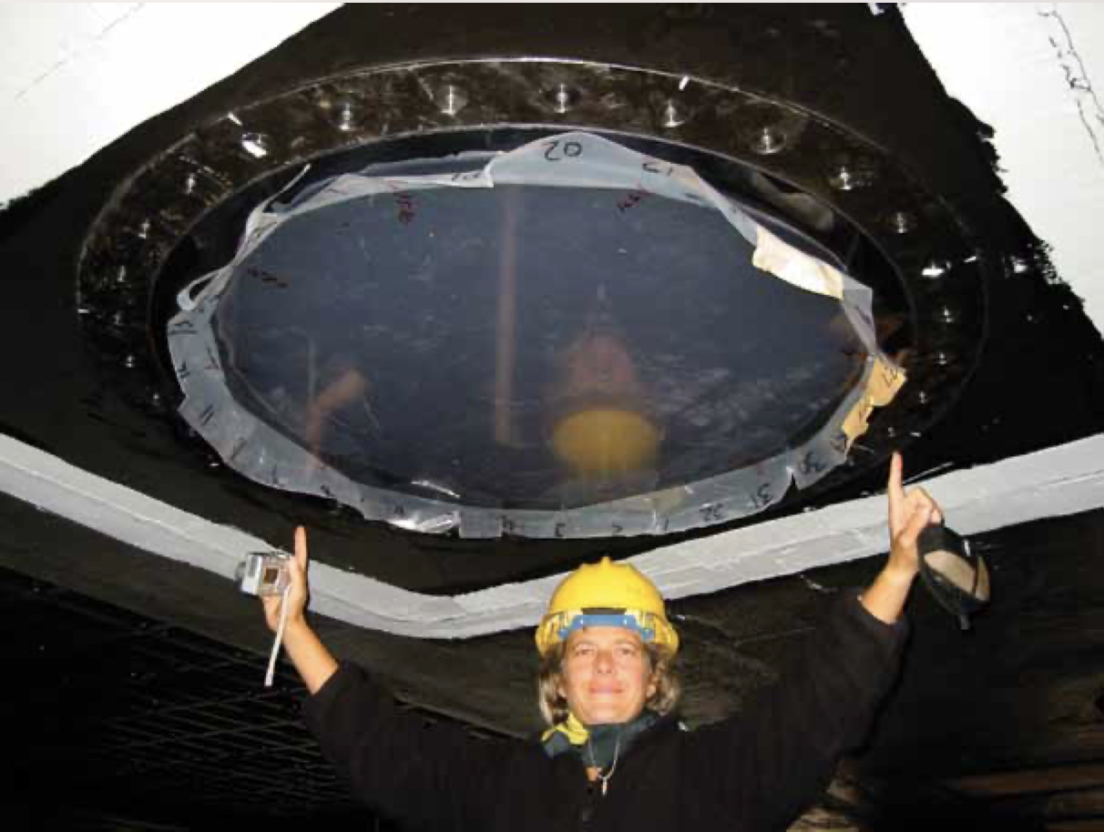 Person in hardhat beneath a large, circular device