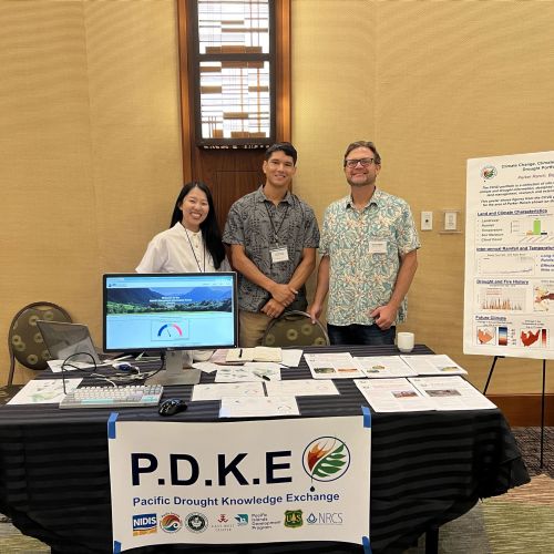 PDKE team at demonstration table at conference