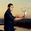 Milton Garces measuring wind speed in preparation for taking infrasound readings at Keahole Point, Hawaii. (Image from Wired.com)