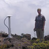 Photo of James Foster next to a GPS station