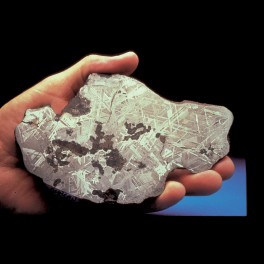 hand holding meteorite section