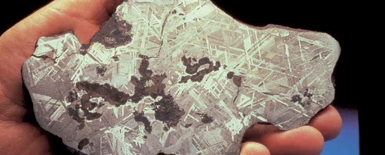 hand holding meteorite section