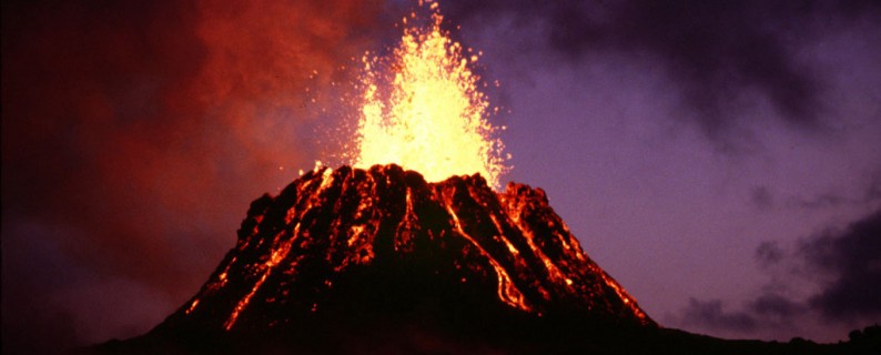 “View at dusk of the young Pu‘u ‘O‘o cinder-and-spatter cone, with fountain approximately 40 m high, during episode 5” by G.E. Ulrich, 6/29/83, GU6830A. courtesy of the U.S. Geological Survey