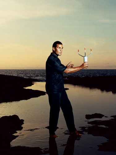 Milton Garces measuring wind speed in preparation for taking infrasound readings at Keahole Point, Hawaii. (Image from Wired.com)