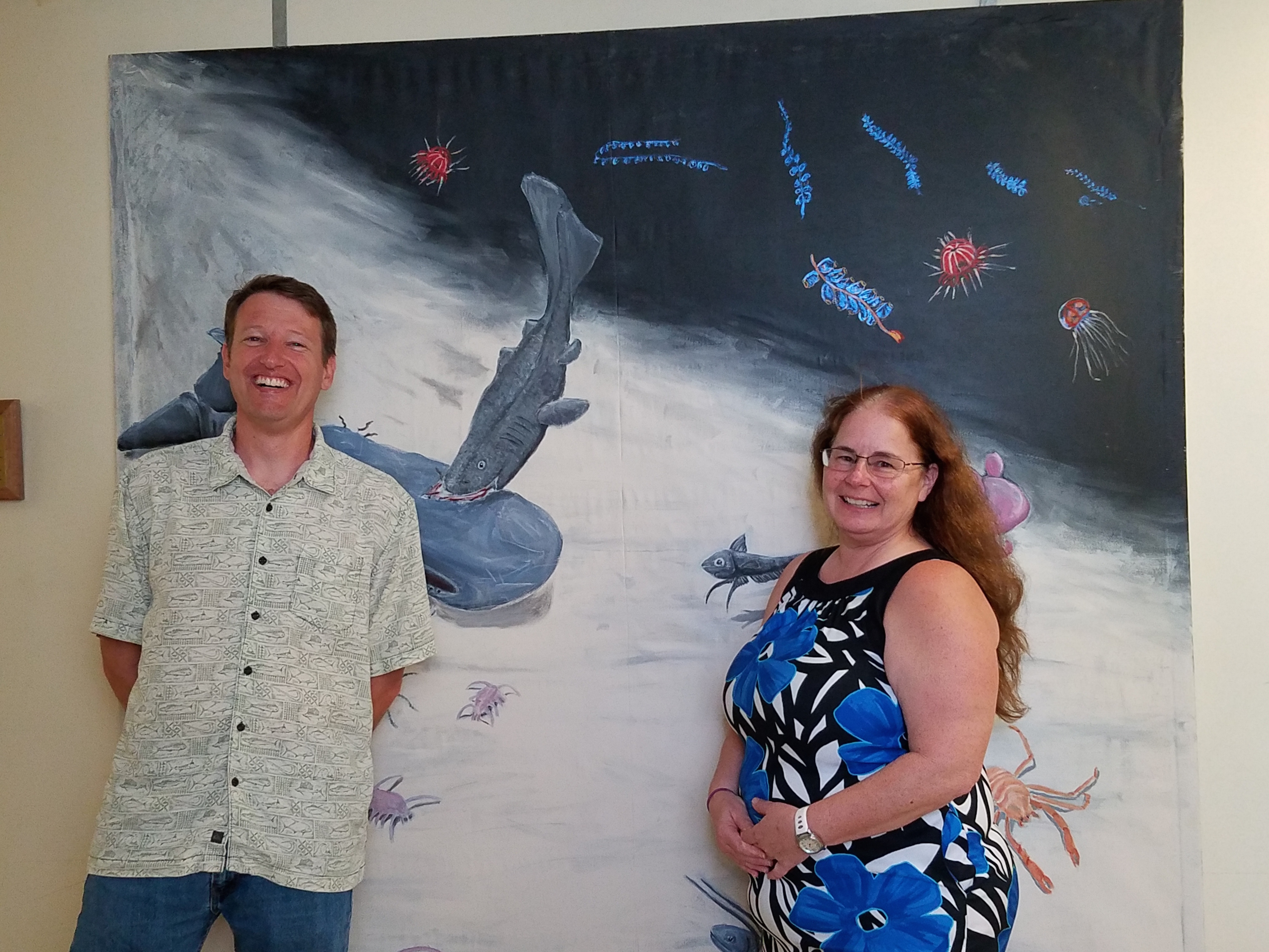 Jeff Drazen and Michelle Smith in front of the mural depicting the abyssal plain.