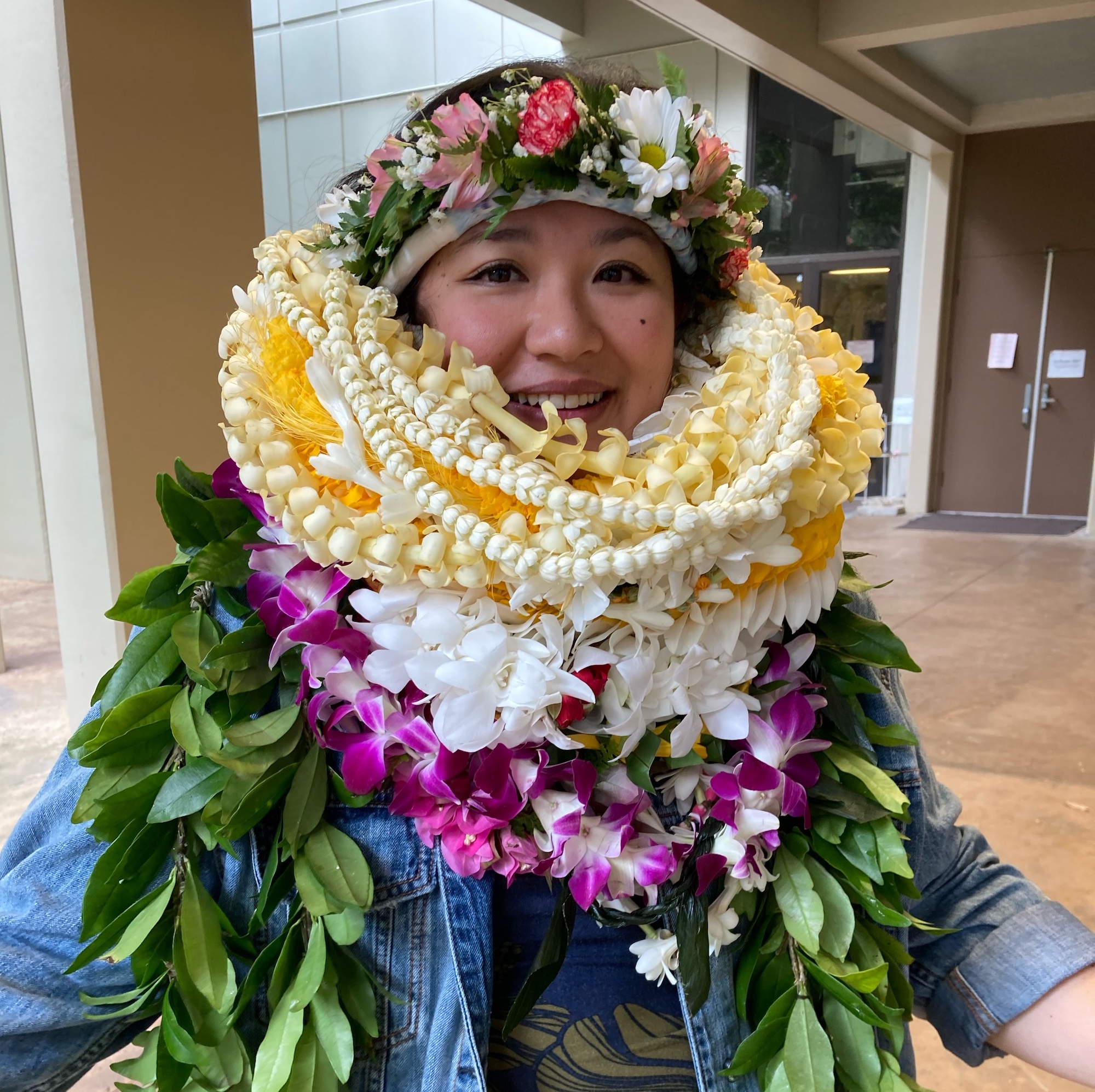 Diamond Tachera with many lei after defending her dissertation