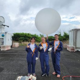 Researchers prepare to launch a weather balloon in Japan (left to right): a graduate students from Colorado State University, SOEST graduate students Mya Sears and Katie Ackerman.