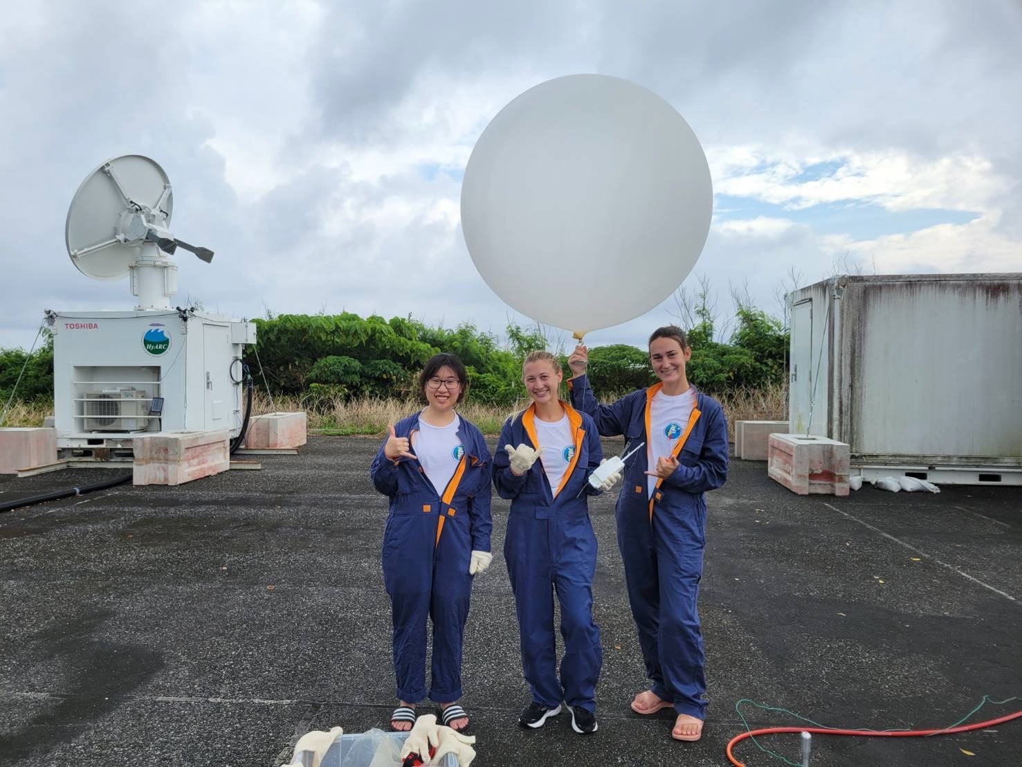 Researchers prepare to launch a weather balloon in Japan (left to right): a graduate students from Colorado State University, SOEST graduate students Mya Sears and Katie Ackerman.
