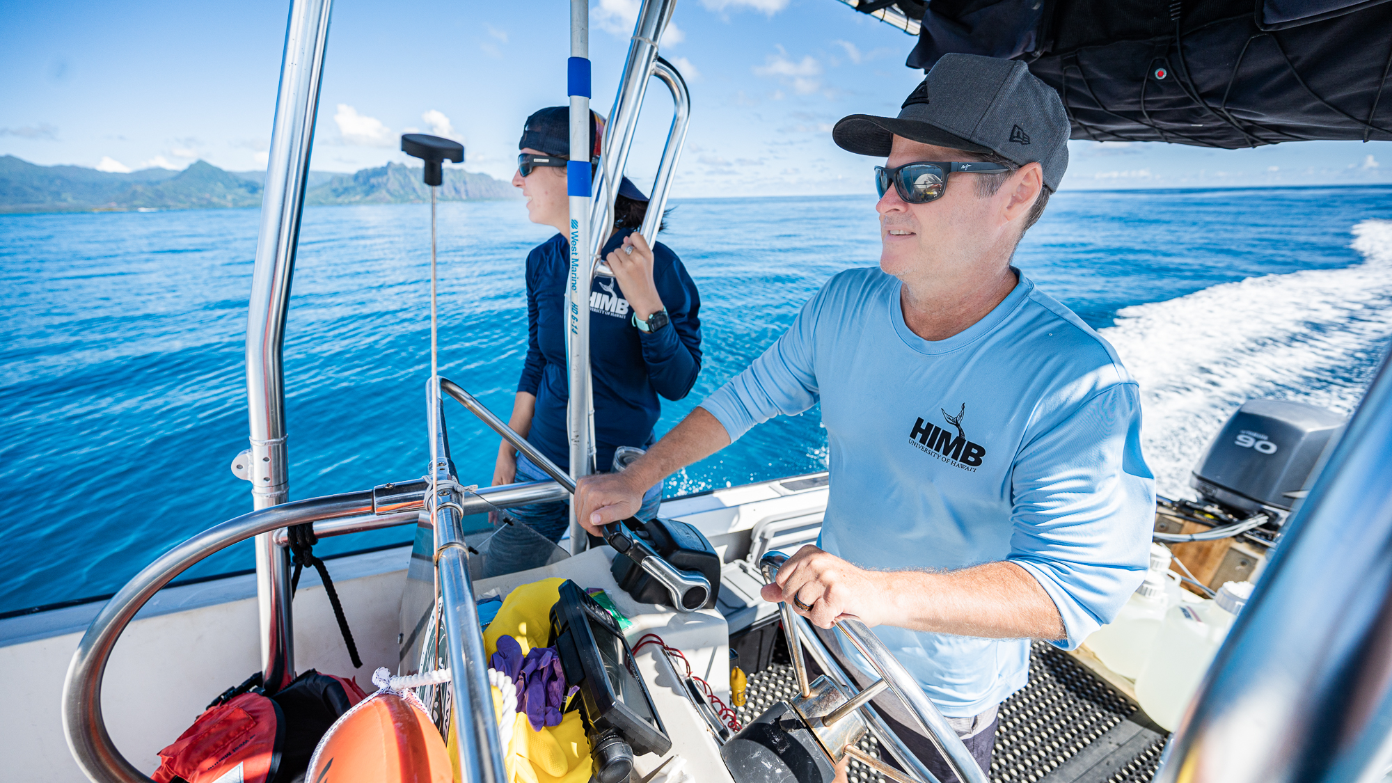 HIMB postdoc Kelle Freel and HIMB researcher Mike Rappé sampling seawater in Kaneohe Bay in order to make growth media and isolate marine bacteria.