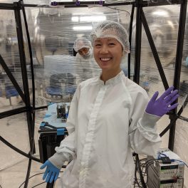 Frances Zhu in the Astrofein Attitude Control Testbed used to test satellite control systems.