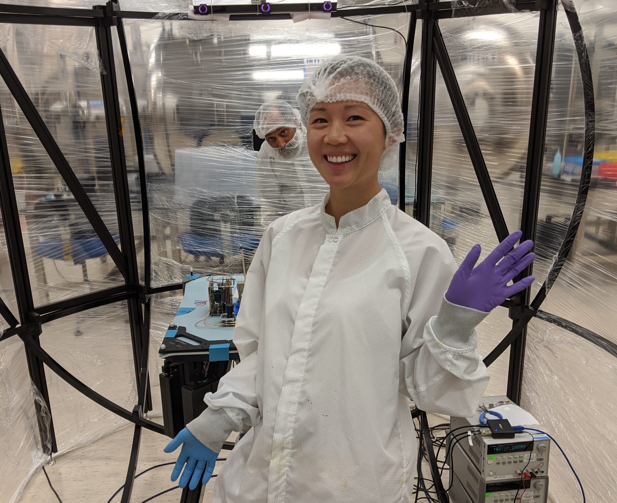 Frances Zhu in the Astrofein Attitude Control Testbed used to test satellite control systems.