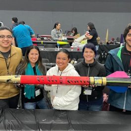Five students holding their rocket.