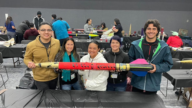 Five students holding their rocket.
