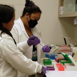 Rosie Alegado (l) and her student Ku'i Keliipuleole working in the lab..