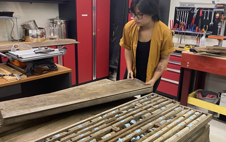 Nabila Nizam, a doctoral candidate in the SOEST Department of Earth Sciences, with Kilauea Iki core samples.