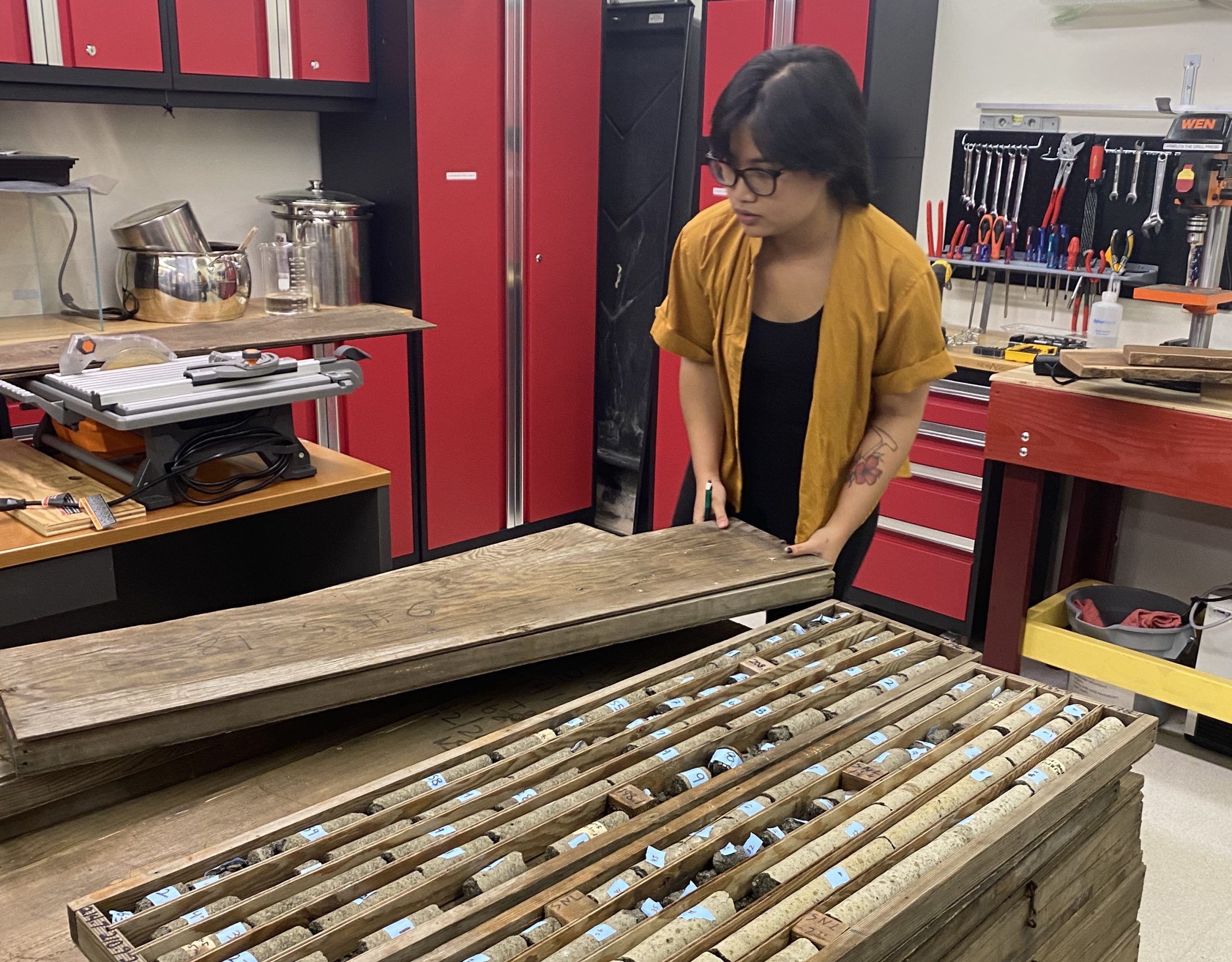 Nabila Nizam, a doctoral candidate in the SOEST Department of Earth Sciences, with Kilauea Iki core samples.