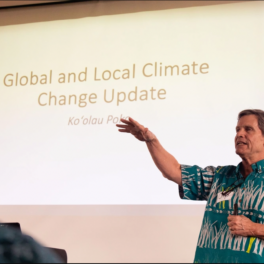 Chip Fletcher stands in front of a slide that reads "Global and local climate change update" during the kickoff meeting for the Ko’olaupoko Resilience Review