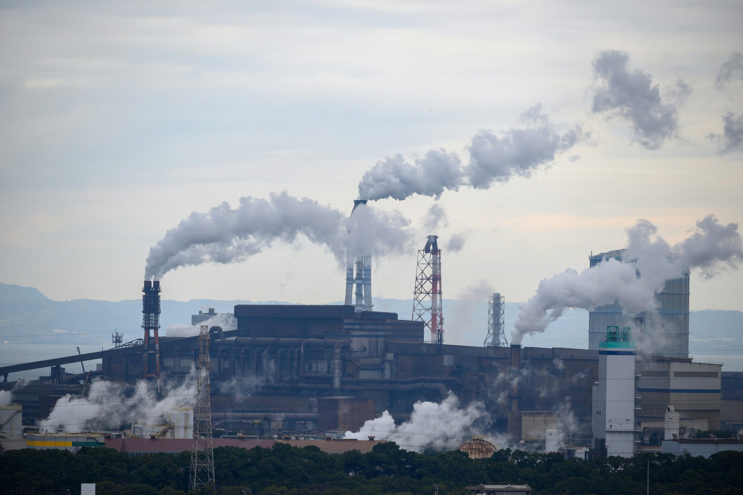 Smoke stacks at a factory pump pollution into the atmosphere.