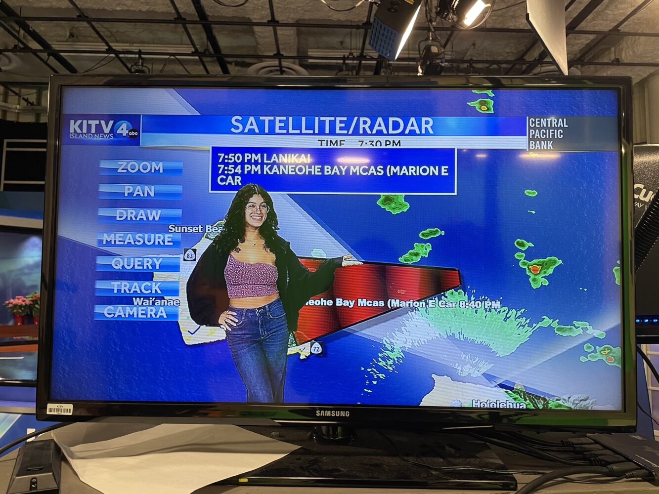 Anamaria Navarrete on a computer screen doing the weather report at a local television station.
