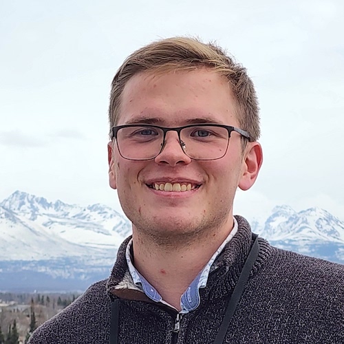 Ian Wynn with mountains in background
