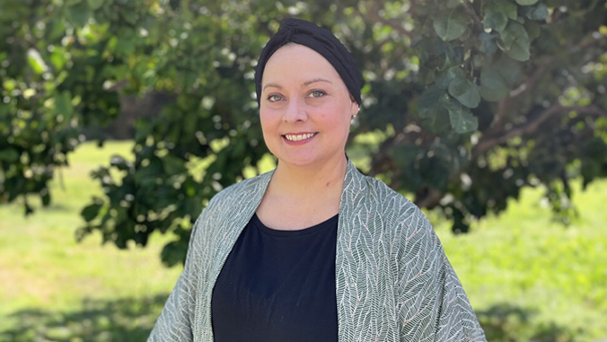 Headshot of Lauren Kaupp in front of greenery