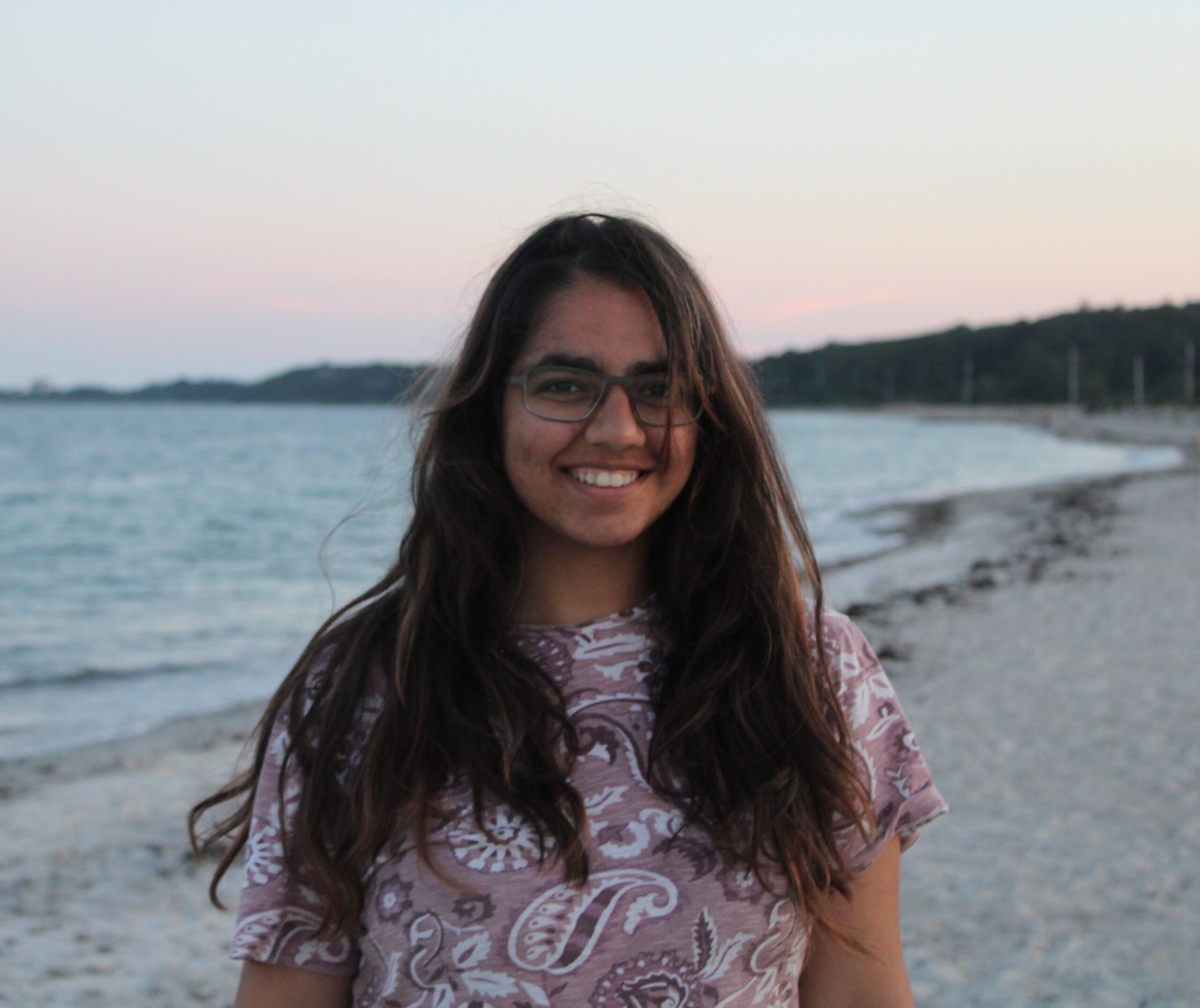 Prajna Jandial standing on the shoreline with the ocean behind her