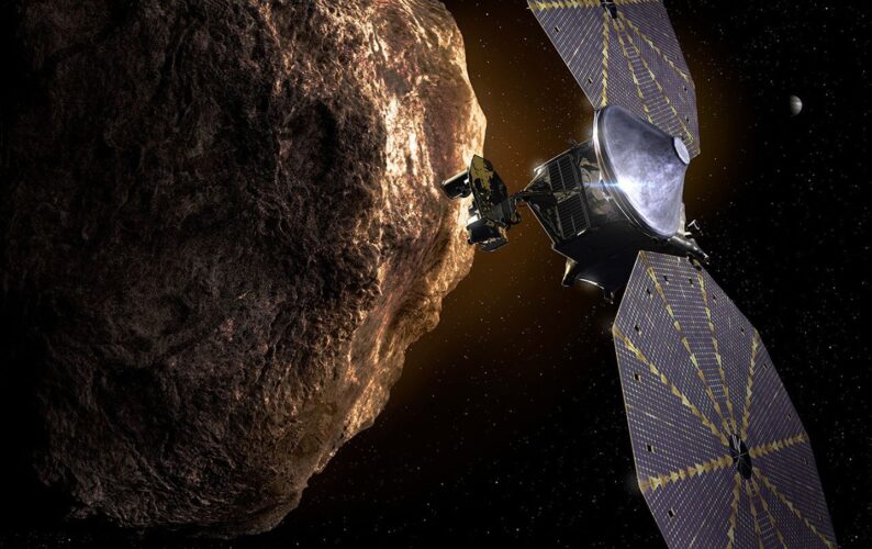 Artist's concept of the Lucy spacecraft approaching the bumpy surface of a Jupiter Trojan asteroid.