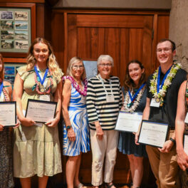 Students and ARCS members stand together smiling with students holding certificates.