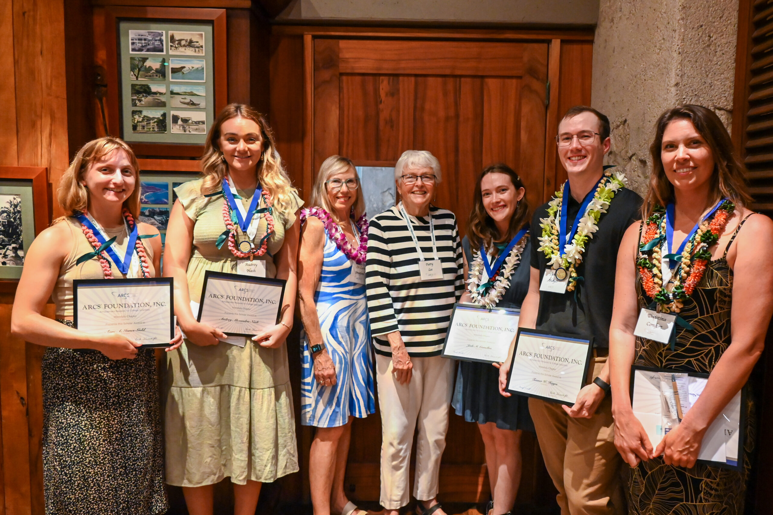 Students and ARCS members stand together smiling with students holding certificates.